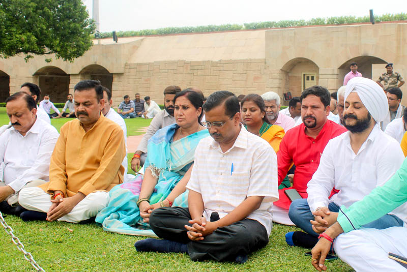 Delhi Chief Minister and AAP Convener Arvind Kejriwal with party MLAs paying tribute to Mahatma Gandhi, at Rajghat in New Delhi on Thursday. (UNI) Delhi Chief Minister and AAP Convener Arvind Kejriwal with party MLAs paying tribute to Mahatma Gandhi, at Rajghat in New Delhi on Thursday. (UNI)