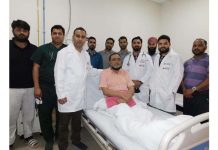 A team of doctors posing with the patient to whom they operated for a rare lung surgery at AOI, ASCOMS Hospital, Jammu.