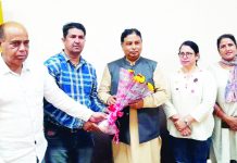 Former Minister Sat Sharma being presented bouquet at MA Stadium Jammu on Sunday.
