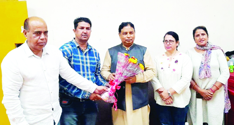 Former Minister Sat Sharma being presented bouquet at MA Stadium Jammu on Sunday. Former Minister Sat Sharma being presented bouquet at MA Stadium Jammu on Sunday.