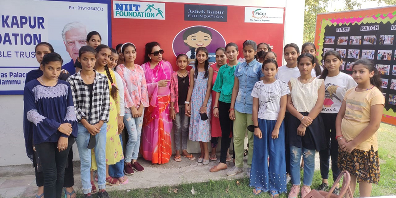 FICCI FLO chairperson Ritu Singh posing photograph with girls at Nagbani in Jammu on Friday.