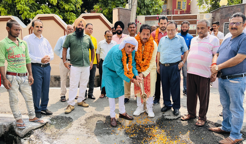 BJP leader, Baldev Singh Billawaria starting tile work at Pushp Enclave in Gangyal on Sunday. BJP leader, Baldev Singh Billawaria starting tile work at Pushp Enclave in Gangyal on Sunday.