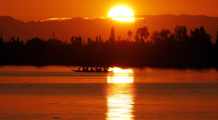 Tourists enjoy shikara ride during Sunset at Dal Lake in Srinagar. -Excelsior/Shakeel