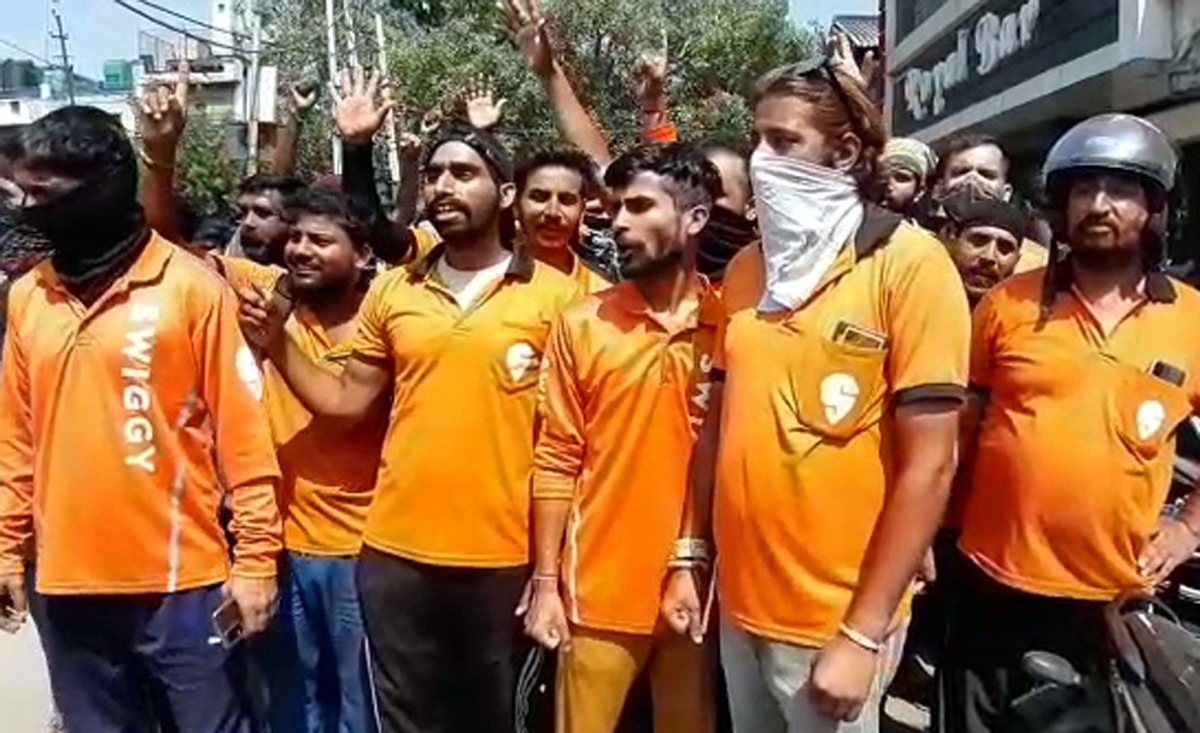 Employees of Swiggy raising slogans during protest at Jammu on Monday.