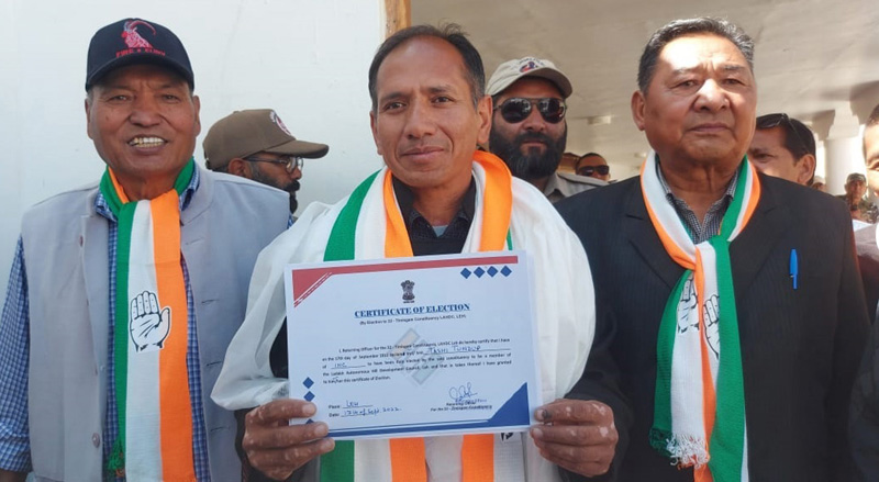 Cong candidate shows victory certificate in Leh on Saturday.
