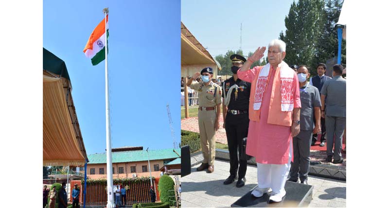 LG Manoj Sinha salutes 120-feet tall national flag at Pulwama on Sunday. -Excelsior/Younis Khaliq