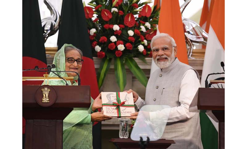 Bangladeshi Prime Minister Sheikh Hasina presenting a book to Prime Minister Narendra Modi after their meeting at Hyderabad House in New Delhi on Tuesday. (UNI)