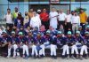 J&K Baseball team posing for a group photograph with former Deputy Chief Minister Kavinder Gupta at MA Stadium.