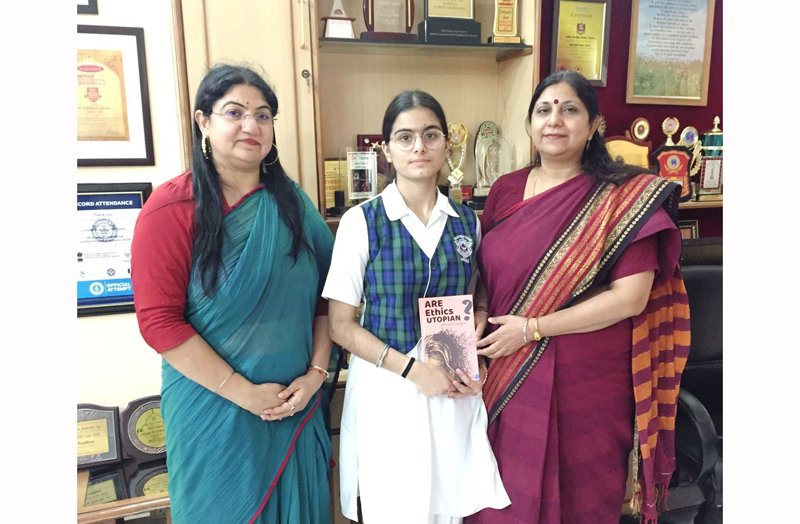 DPS student Khushi Dogra displaying her book while posing for group photograph with School Principal Ruchi Chabra at Jammu on Tuesday.