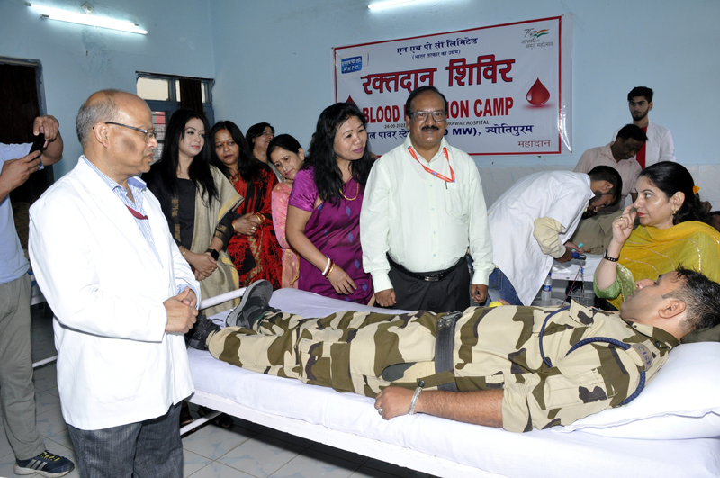 Dignitaries and a security person during Blood Donation Camp.