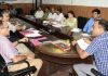 Divisional Commissioner chairing a meeting.