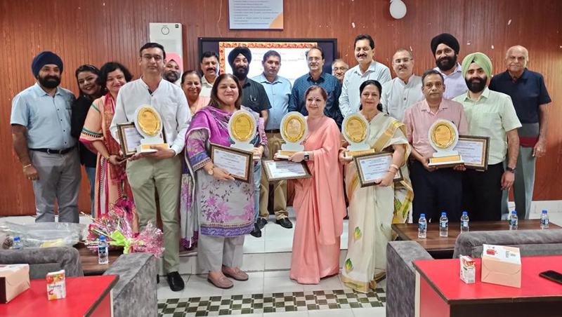Meritorious teachers posing with their awards during a function at Jammu.