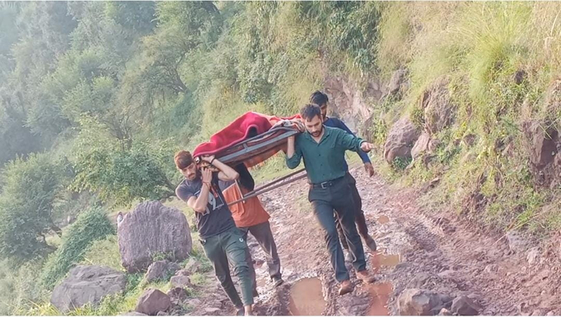 Villagers carrying pregnant woman to hospital on cot in Nowshera. — Excelsior/Imran