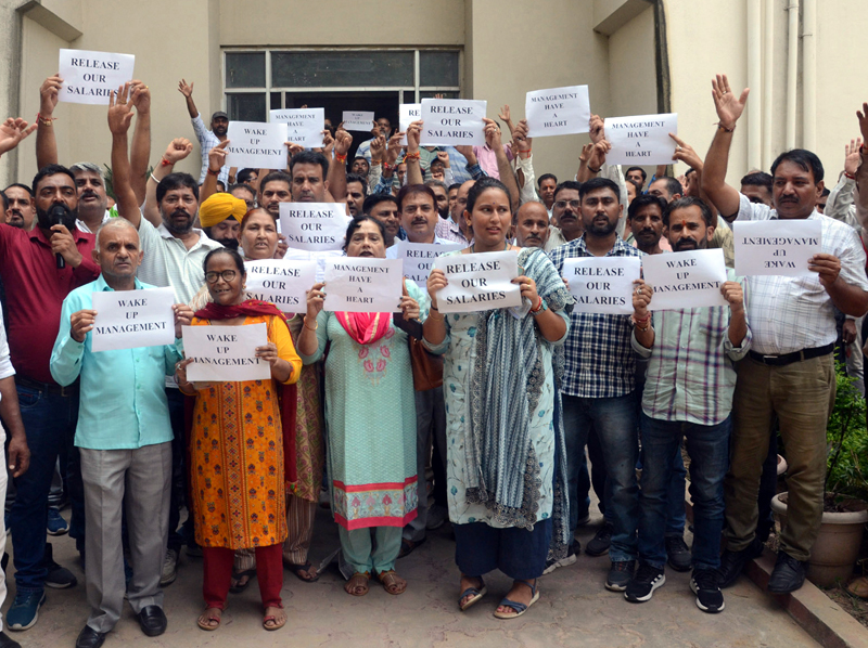 JKPCC employees staging protest for release of their four months salaries, at Railhead Complex in Jammu on Friday. -Excelsior/ Rakesh JKPCC employees staging protest for release of their four months salaries, at Railhead Complex in Jammu on Friday. -Excelsior/ Rakesh