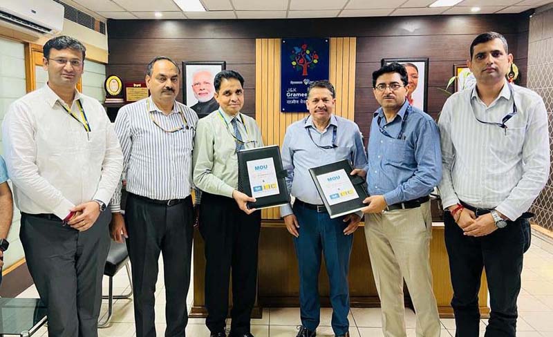 Officials of LIC and J&K Grameen Bank displaying MoU copy at Grameen Bank Head Office Narwal in Jammu on Thursday.