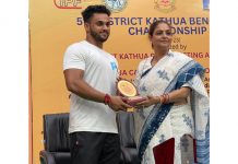 A winner being awarded with trophy by a dignitary at Kathua on Friday.