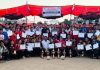 Winners displaying trophies certificates while posing for a group photograph along with dignitaries at Udhampur on Saturday.