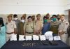 Cops pose with terror associates and recoveries made from them in Poonch on Friday.