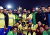 Winning team of a friendly T-20 match posing with the trophy.