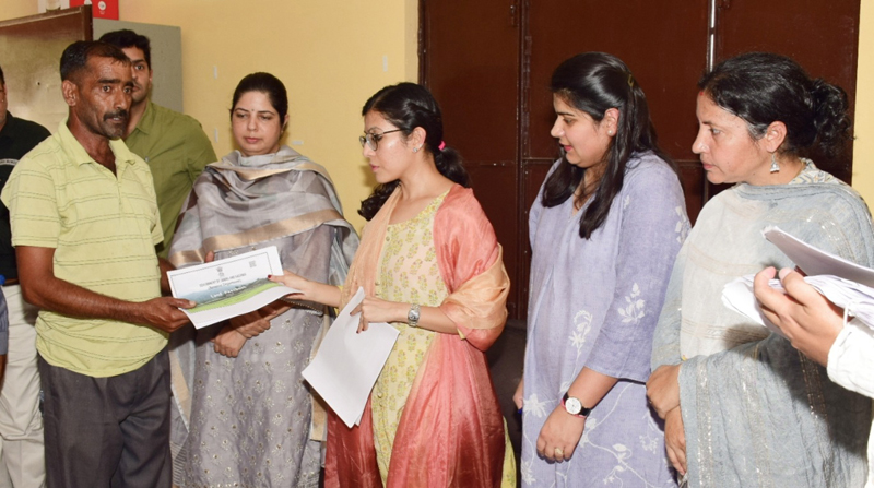 DC Jammu Avny Lavasa distributing land passbook to land owners at Palanwala. DC Jammu Avny Lavasa distributing land passbook to land owners at Palanwala.