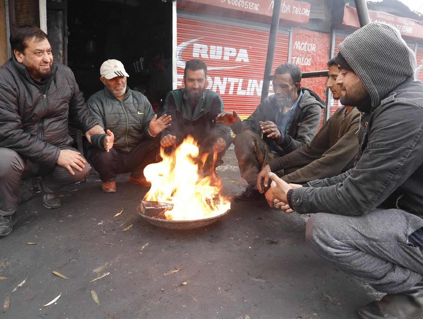 People warm themselves on a cold morning day in Srinagar.Excelsior/Shakeel