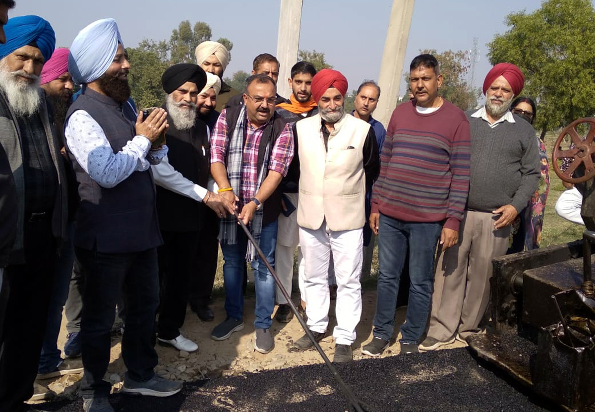 JMC Councillor, Dr Yudhvir Singh and BJP leader, Vikram Randhawa starting road blacktopping work at Bhour Camp on Tuesday. JMC Councillor, Dr Yudhvir Singh and BJP leader, Vikram Randhawa starting road blacktopping work at Bhour Camp on Tuesday.