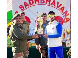 Army officer presenting trophy to captain of the winning team at Kishtwar on Monday.