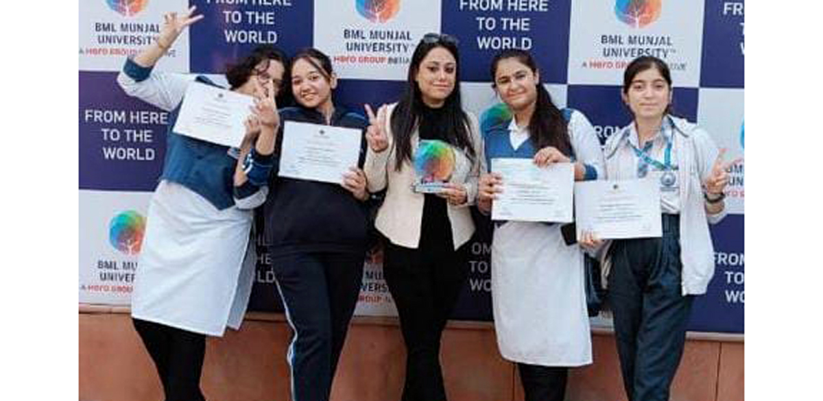 Winners displaying certificates while posing for a group photograph.