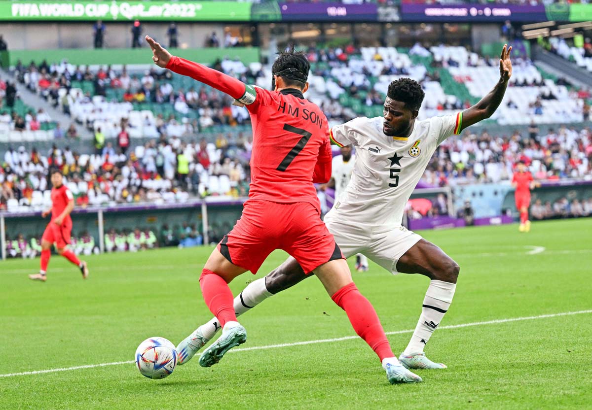 Son Heung-min (L) of South Korea vies with Thomas Partey of Ghana during the Group H match between South Korea and Ghana at Education City Stadium in Al Rayyan, Qatar.