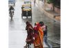 People crossing road amidst heavy rain in Jammu on Wednesday. — Excelsior/Rakesh
