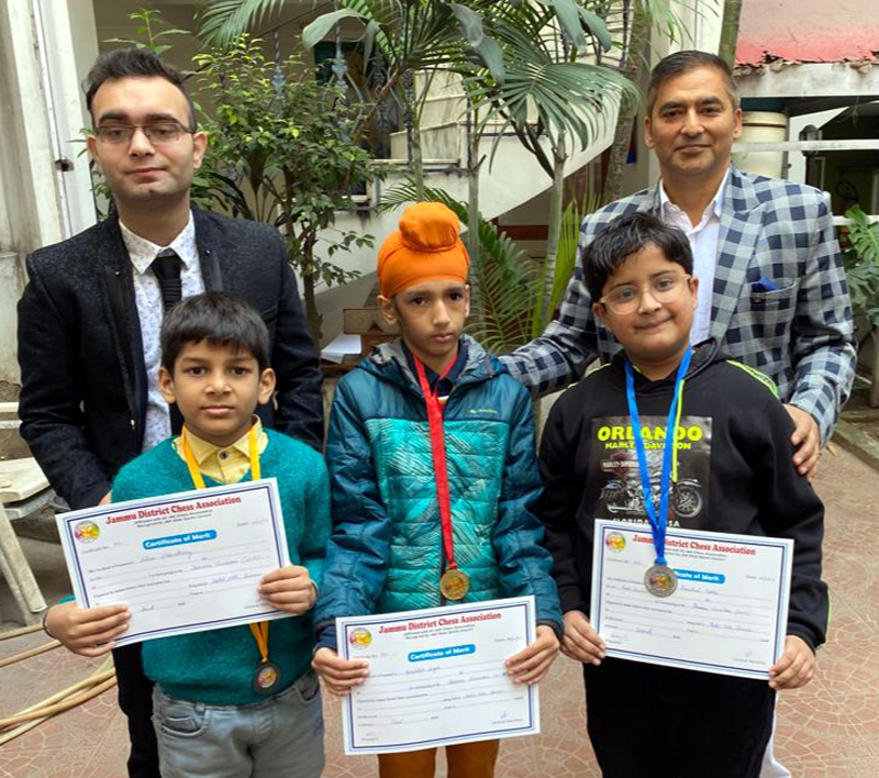 Winners of Chess displaying certificates while posing with president Chess Association Atul Gupta at Jammu on Saturday.