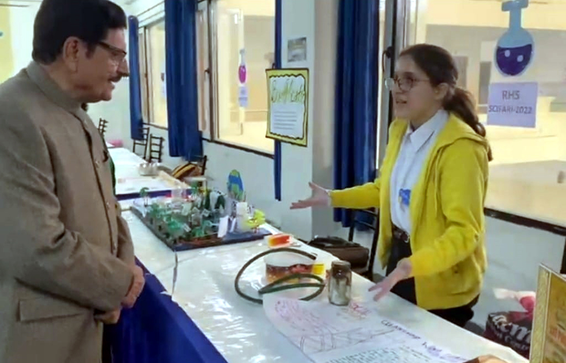 A student demonstrating scientific model to a dignitary at Rich Harvest School on Saturday. A student demonstrating scientific model to a dignitary at Rich Harvest School on Saturday.