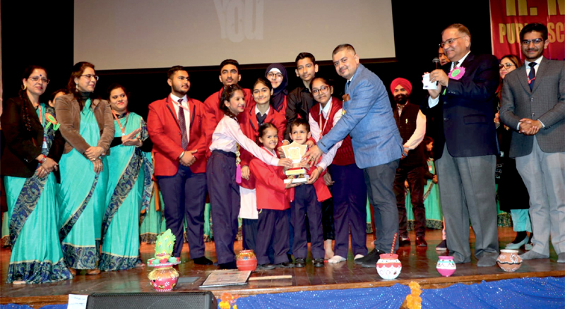 A kid being awarded with trophy by dignitaries during ‘Annual Day’ of R M Public School at Jammu on Friday.