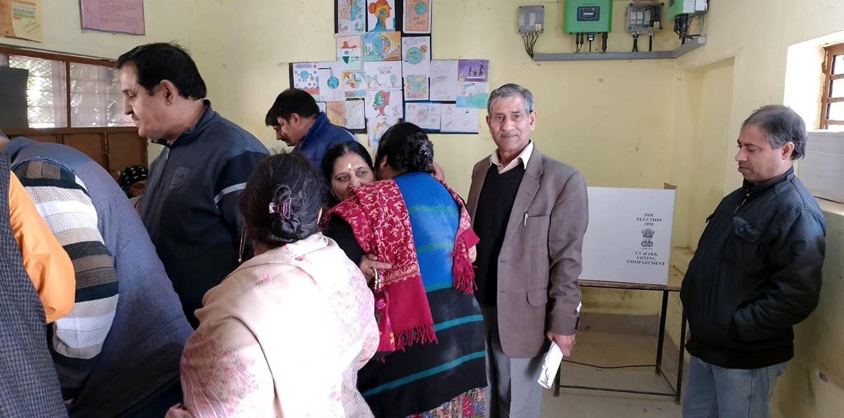 Migrant voters at a polling booth in Patta Bohri waiting to cast their vote on Monday.