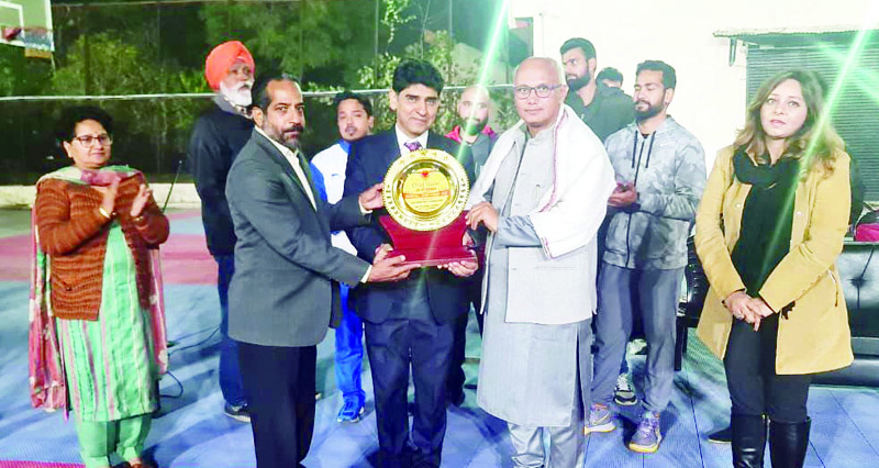 Mayor Rajinder Sharma presenting trophy to an official at MA Stadium on Tuesday. Mayor Rajinder Sharma presenting trophy to an official at MA Stadium on Tuesday.