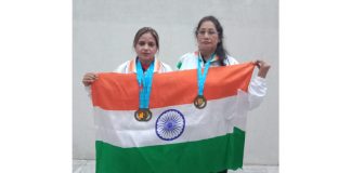 Sudesh Basotra and Shahida Parveen posing together while holding Tricolour after winning bronze medals.