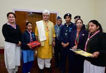 Lt Governor Manoj Sinha with officers & volunteers of J&K Bharat Scouts & Guides posing for a group photograph.