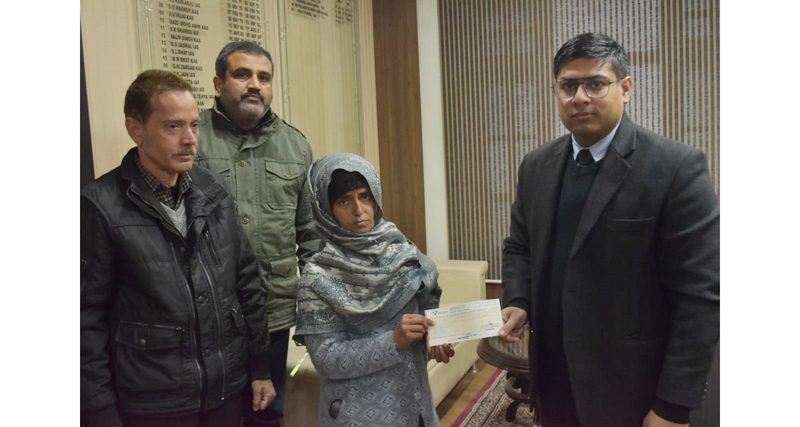DC Vikas Kundal giving cheque to a beneficiary in Rajouri. DC Vikas Kundal giving cheque to a beneficiary in Rajouri.