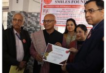 Jammu Mayor Rajinder Sharma presenting appreciation certificate to Dr Rahul Sharma (Orthospine Specialist) during a medical camp in Jammu.