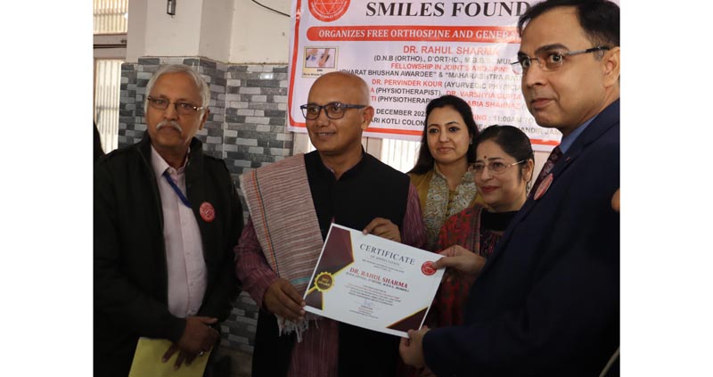 Jammu Mayor Rajinder Sharma presenting appreciation certificate to Dr Rahul Sharma (Orthospine Specialist) during a medical camp in Jammu.