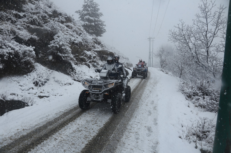 Tourists enjoy snow scooty ride in Tangmarg area of Baramulla on Friday.   -Excelsior/Aabid Nabi