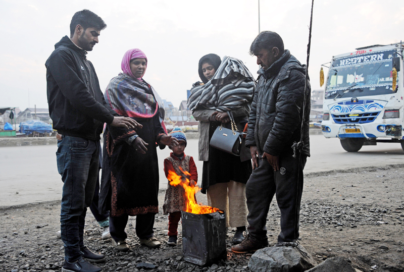 People warm themselves near a bonfire in Srinagar on Friday. -Excelsior/Shakeel People warm themselves near a bonfire in Srinagar on Friday. -Excelsior/Shakeel