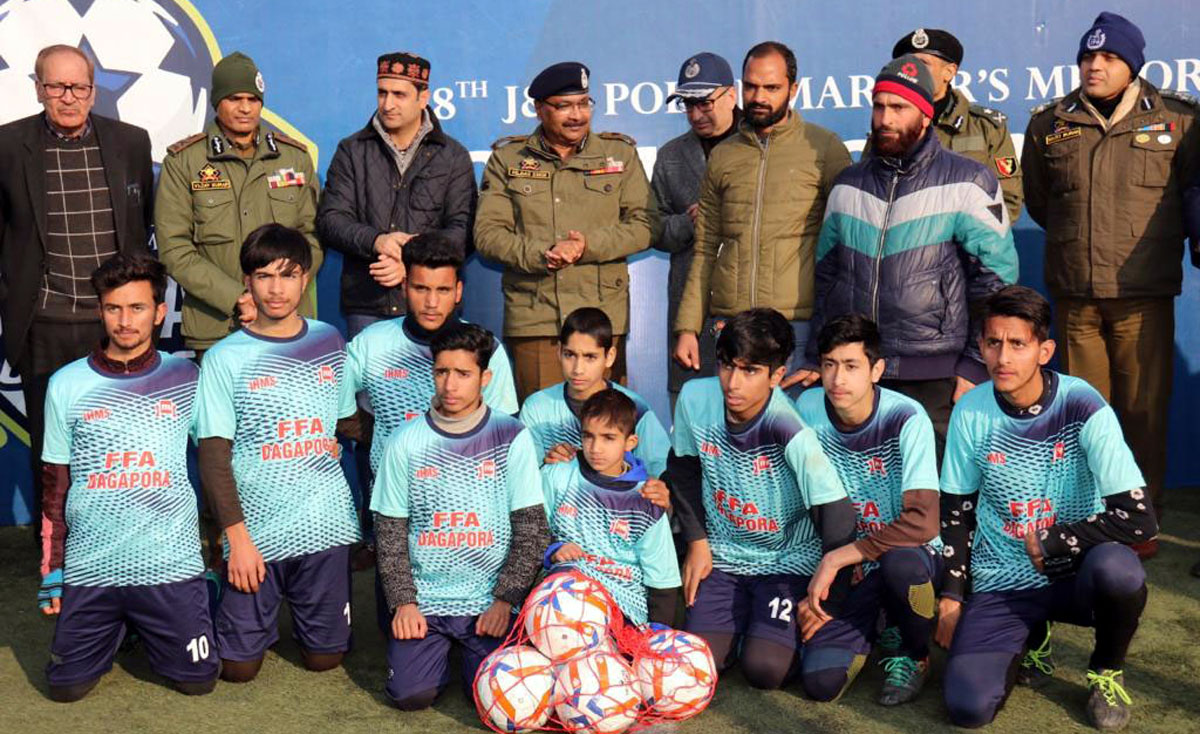 Players posing for a group photograph along with DGP Dilbag Singh and others at TRC Ground, Srinagar on Tuesday. Players posing for a group photograph along with DGP Dilbag Singh and others at TRC Ground, Srinagar on Tuesday.