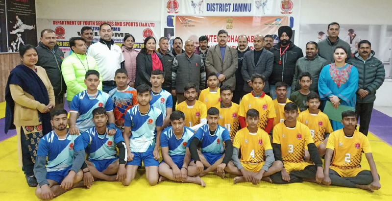 Member Parliament Jugal Kishore posing with participants of tournament and others at Khel Gaon Nagrota on Monday.