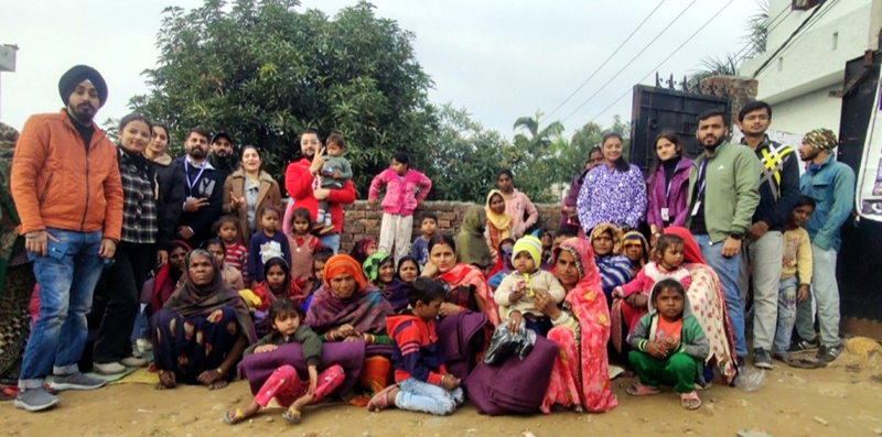 Slum dwellers posing for a group photograph with the NGO LFO-BHF after getting warm clothes in Jammu on Monday. Slum dwellers posing for a group photograph with the NGO LFO-BHF after getting warm clothes in Jammu on Monday.
