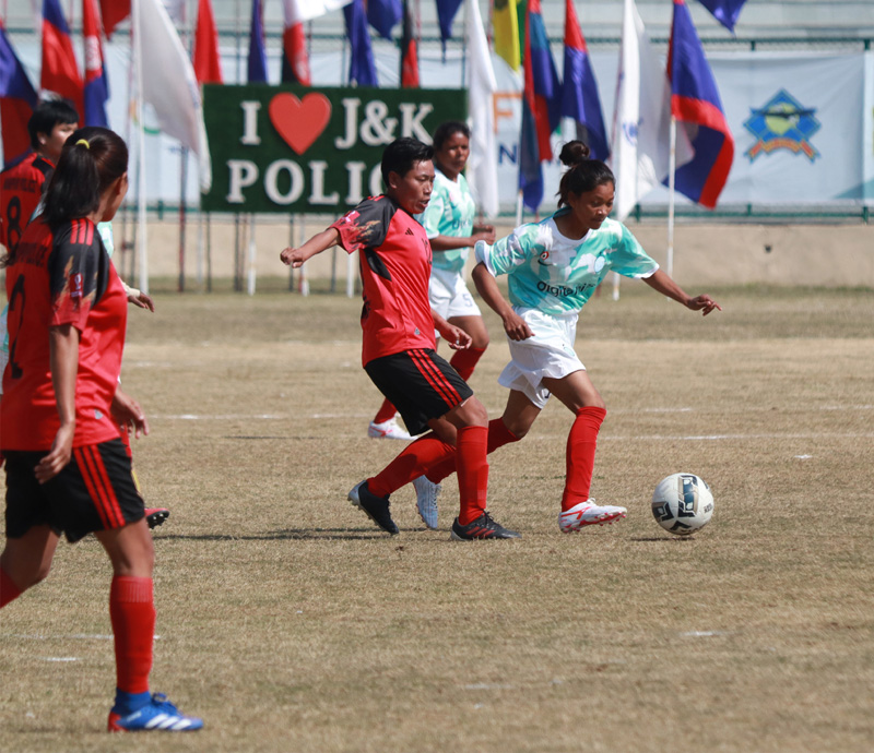Players in action during the All India Police Football match between Manipur Police Women and Jharkhand Police Women at Bakshi Stadium in Srinagar on Tuesday. - Excelsior/Shakeel