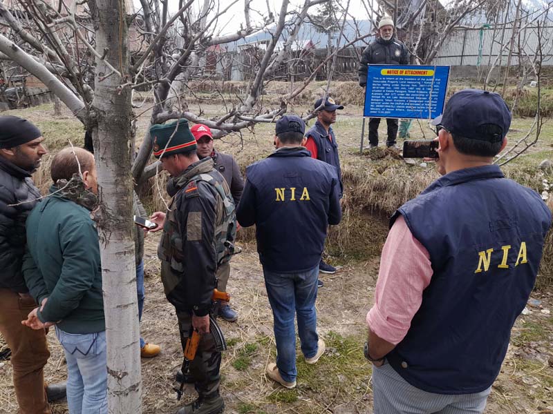 NIA team attaches property of HM militant in Kupwara on Saturday. -Excelsior/Aabid Nabi NIA team attaches property of HM militant in Kupwara on Saturday. -Excelsior/Aabid Nabi