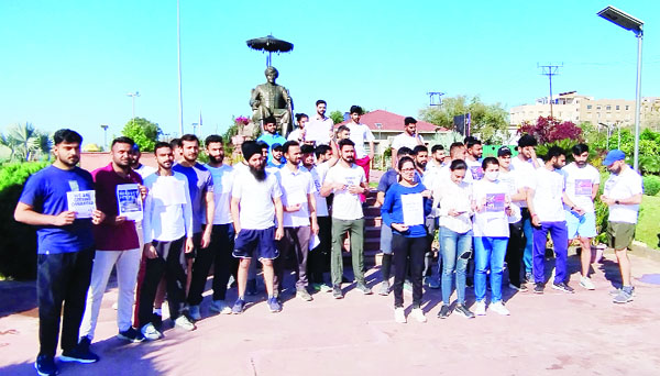 JKPSI aspirants staging a peaceful protest at Maharaja Hari Singh Park in Jammu on Sunday. JKPSI aspirants staging a peaceful protest at Maharaja Hari Singh Park in Jammu on Sunday.