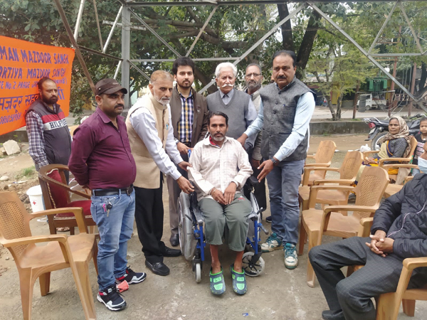 Red Cross personnel and workers of BMS give wheel chair to a needy person at a camp in Jammu on Monday. Red Cross personnel and workers of BMS give wheel chair to a needy person at a camp in Jammu on Monday.