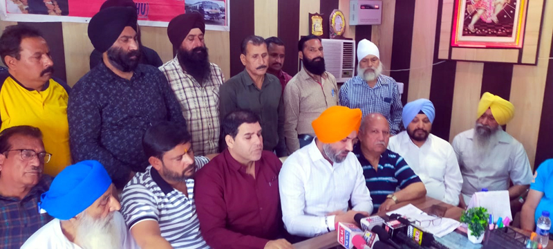 Chairman, All J&K Transport Welfare Association, Ajit Singh, flanked by others, addressing press conference in Jammu. Chairman, All J&K Transport Welfare Association, Ajit Singh, flanked by others, addressing press conference in Jammu.